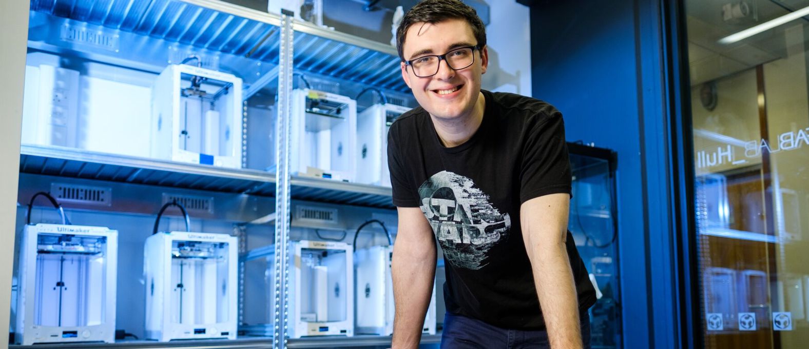 A student in the Swift Additive Manufacturing Space with 3D printed equipment