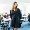 Student stood posing in front of classroom
