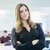 Student stood posing in front of classroom