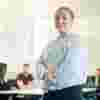 Student stood posing in front of classroom
