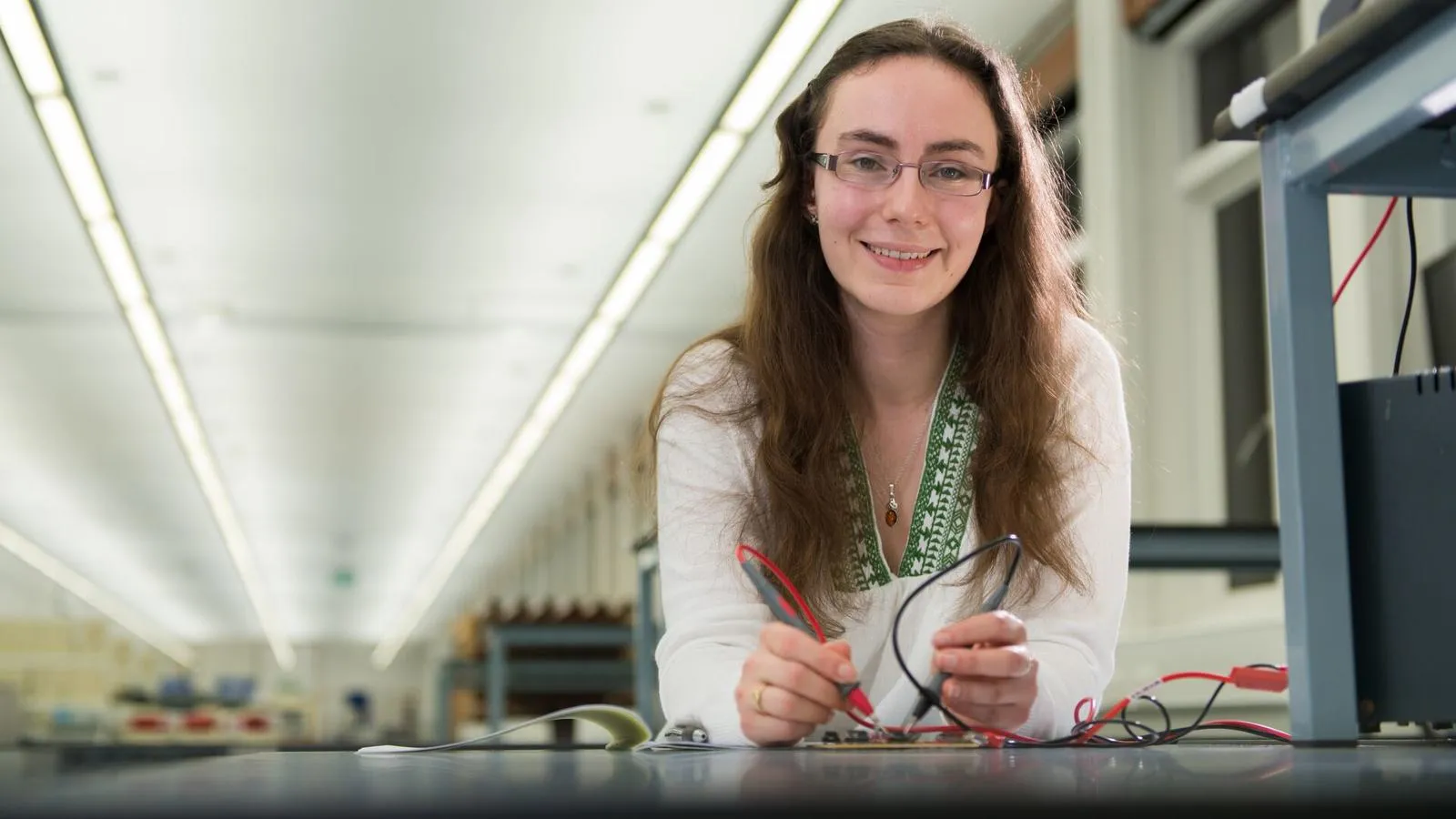 Student sitting at a workbench in the Electronics Workshop at the University of Hull