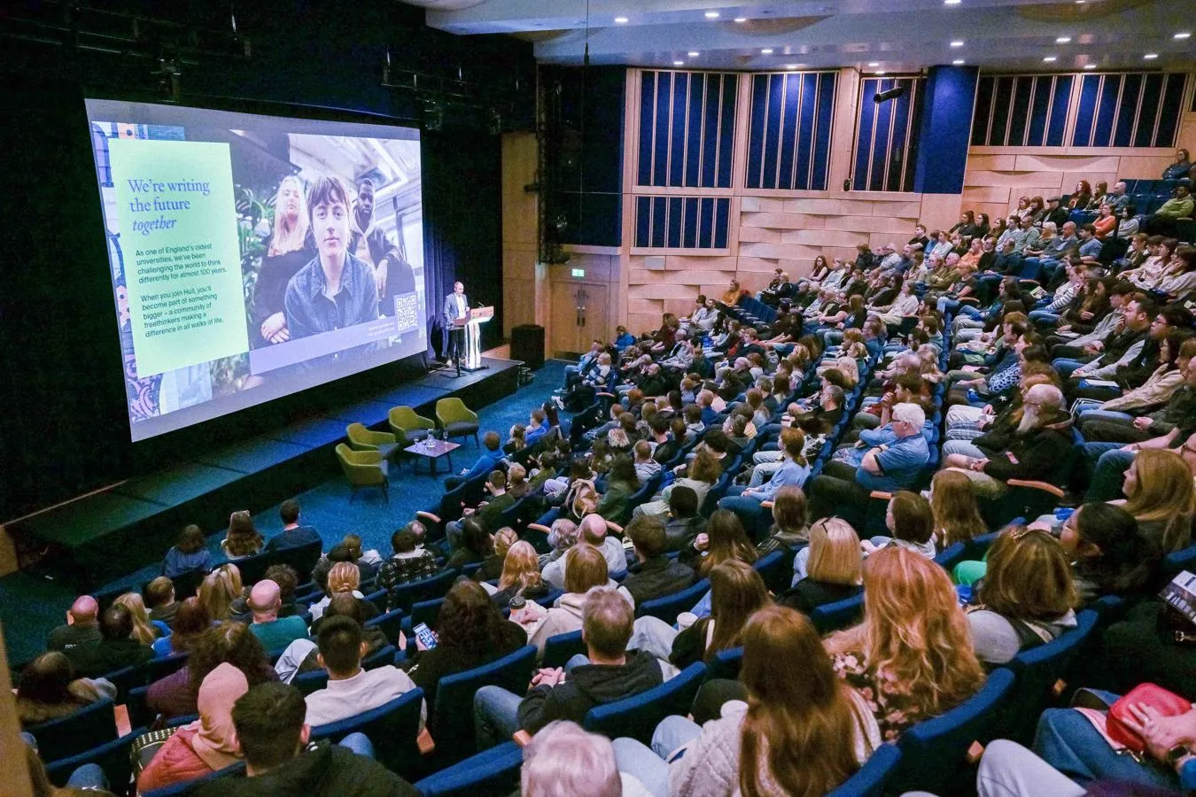 A room full of people listening to the welcome talk at an open day