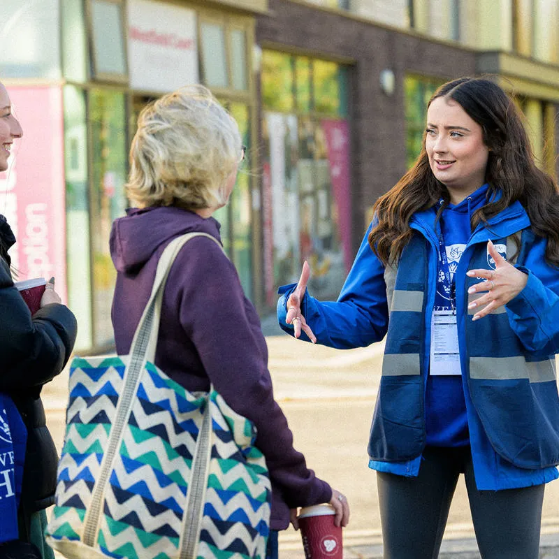 A member of staff touring some prospective students around campus