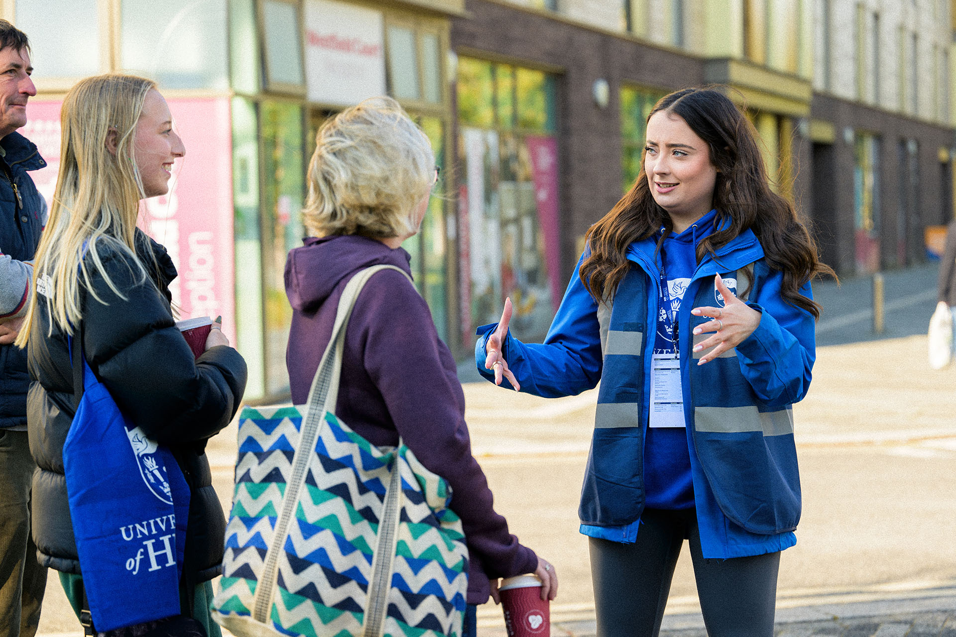 A member of staff touring some prospective students around campus