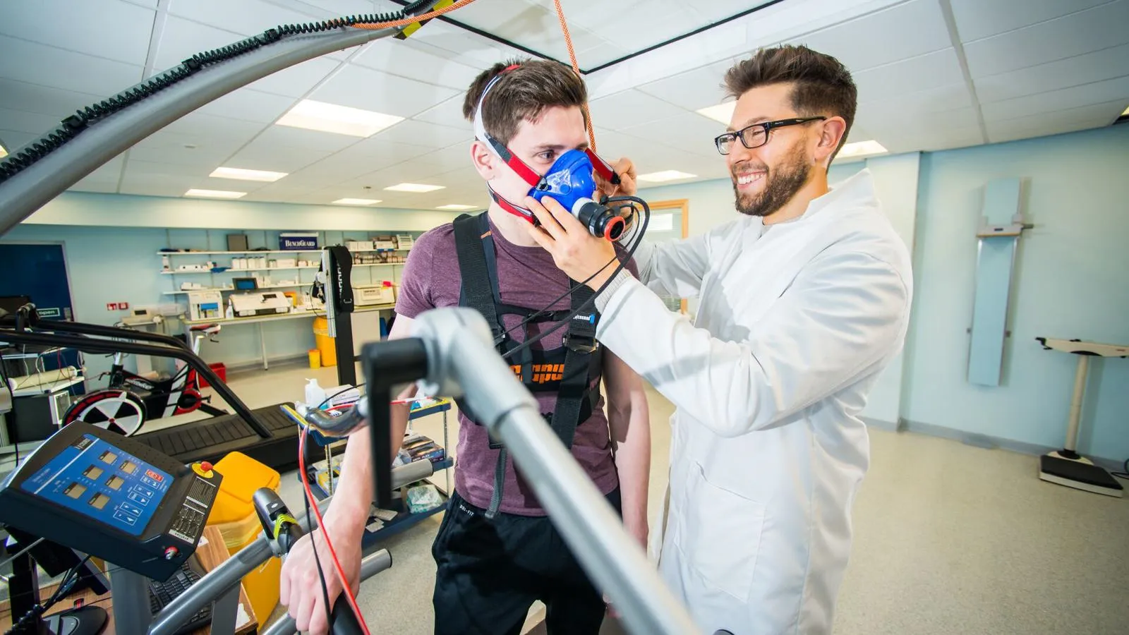 Two students putting a breathing mask on