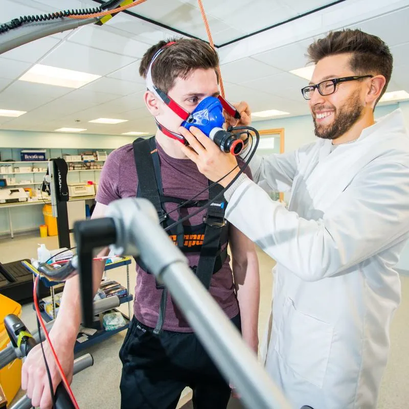 Two students putting a breathing mask on