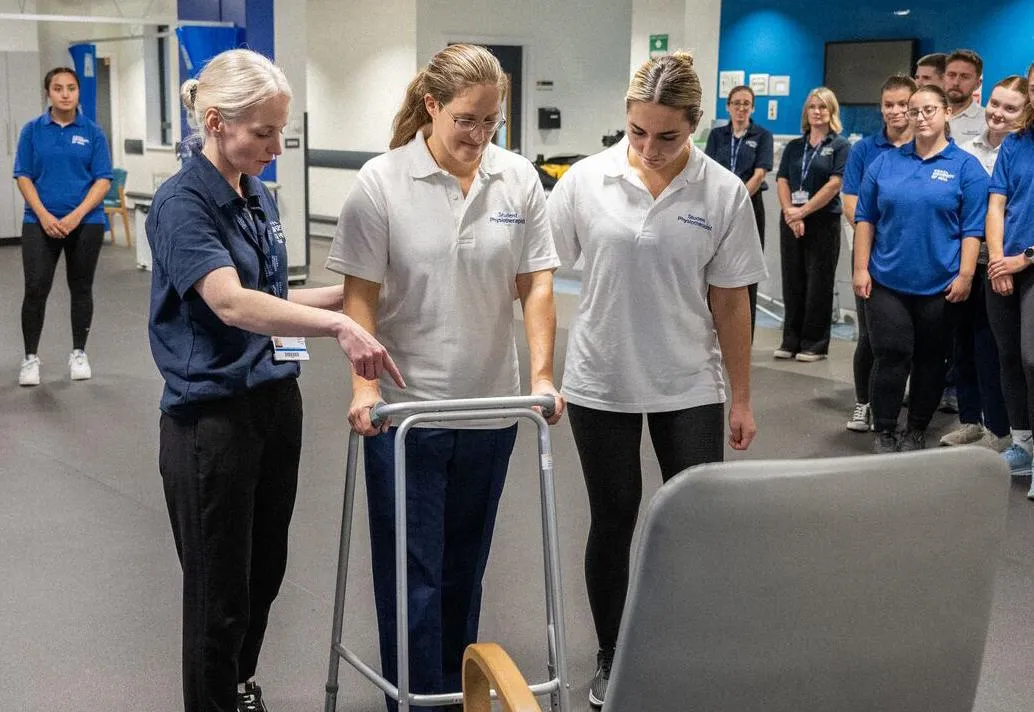 A group of students watching a physiotherapy practical