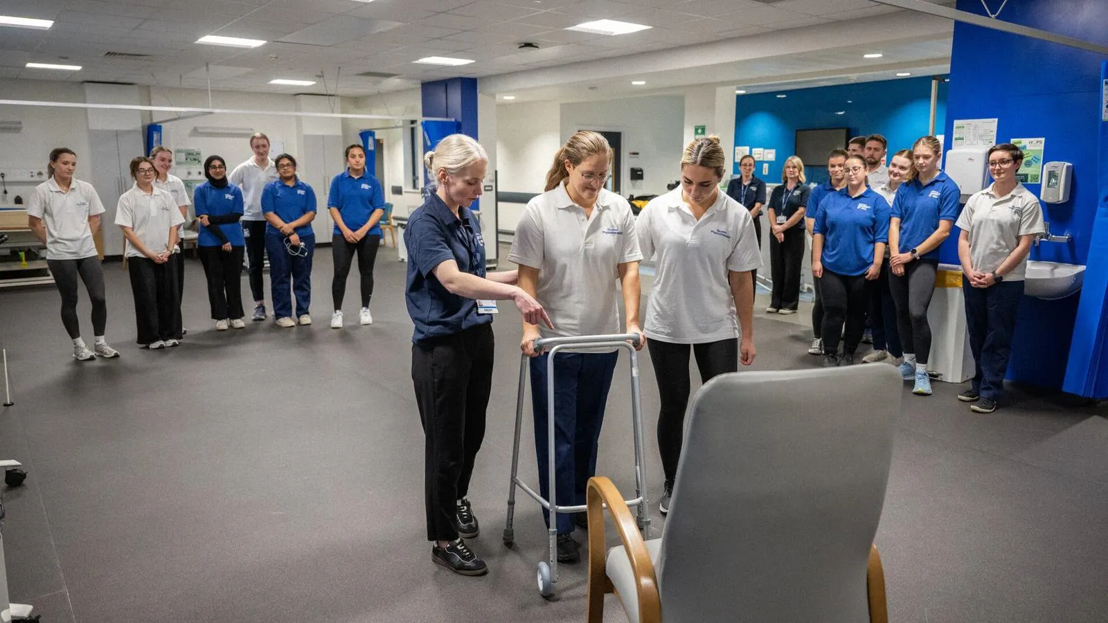 A group of students watching a physiotherapy practical