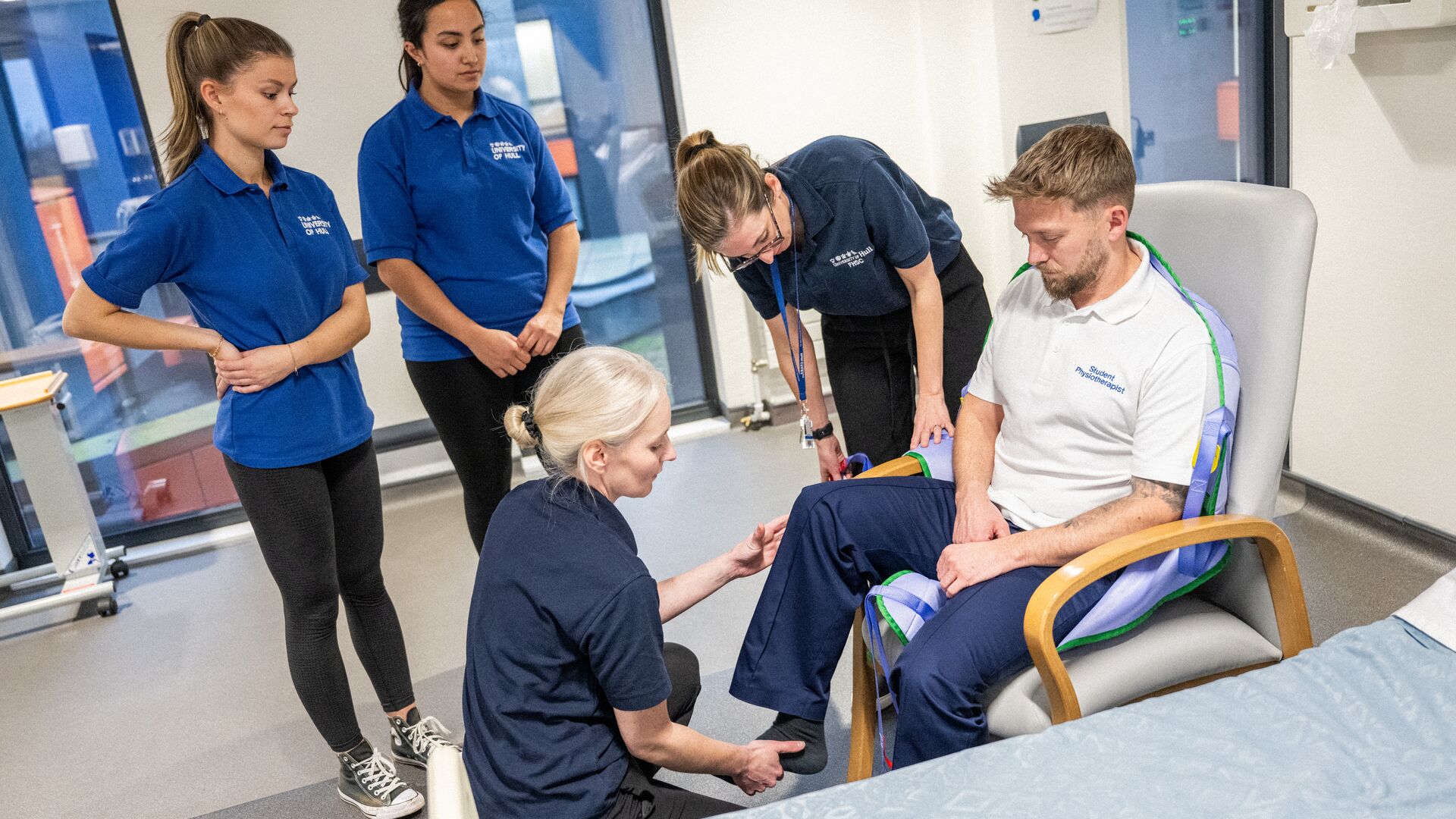 A Group of students watching a physiotherapy practical