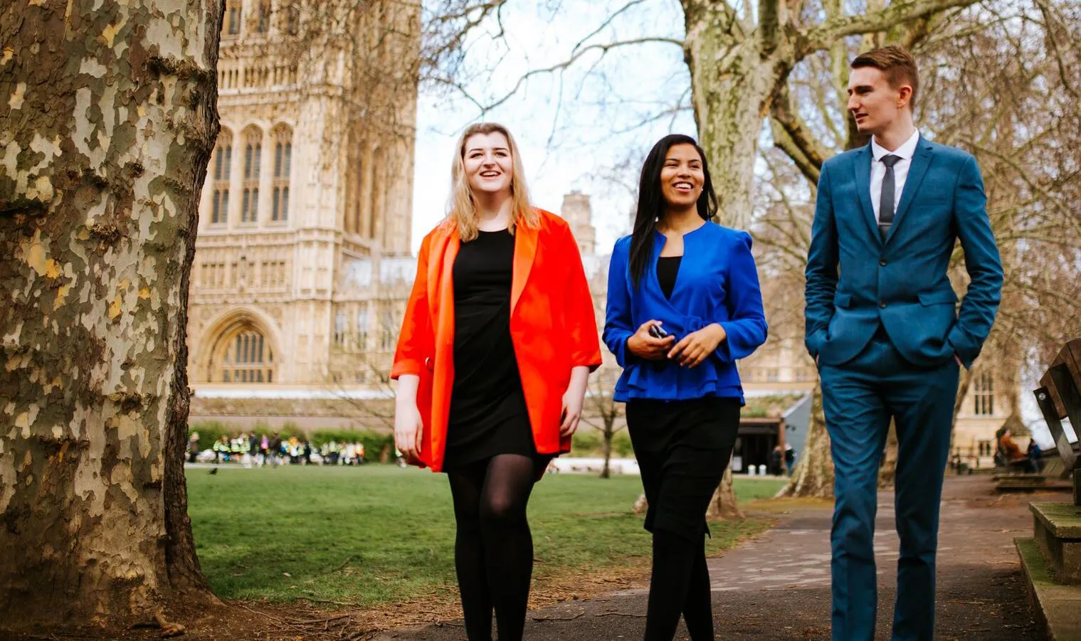 Three of our politics students walking and chatting outside the Houses of Parliament.