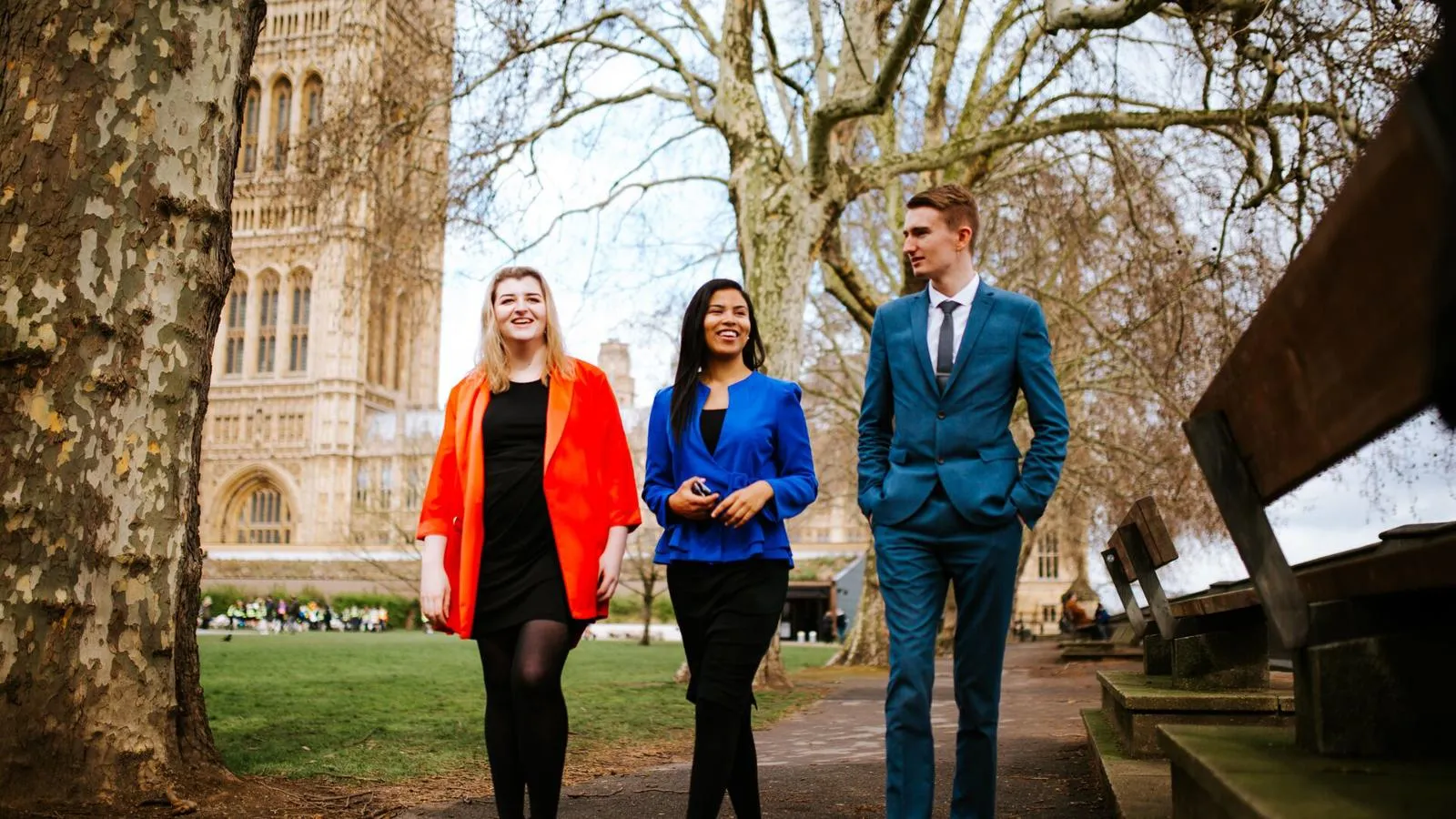 Three of our politics students walking and chatting outside the Houses of Parliament.