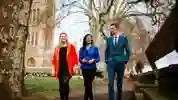 Three of our politics students walking and chatting outside the Houses of Parliament.