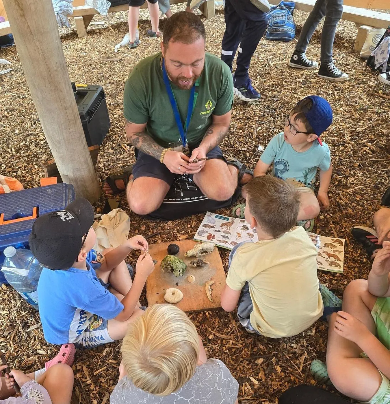 A group of young students sat on the ground
