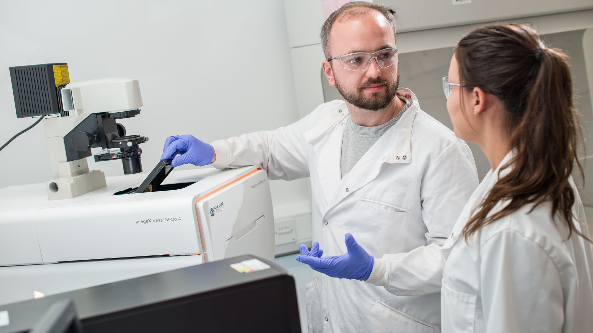 Two doctors using medical research equipment