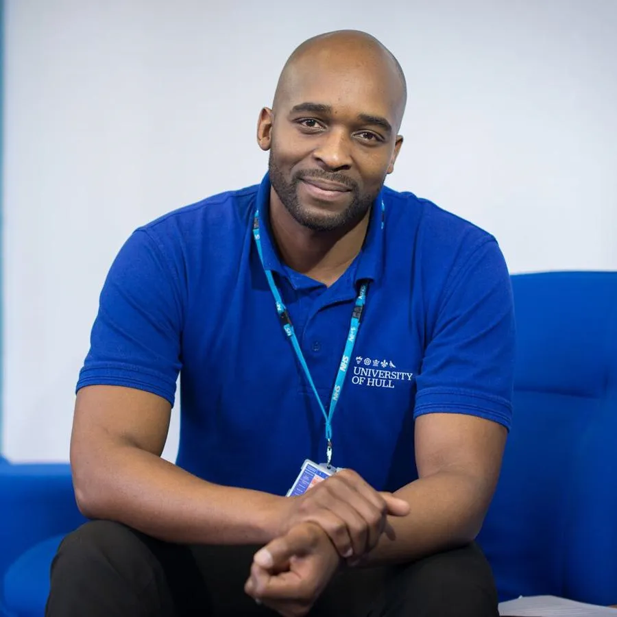 A mental health nursing student in a blue polo shirt