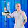 A student nurse with blonde hair wearing a white uniform