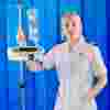 A student nurse with blonde hair wearing a white uniform
