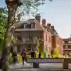 Students walking past University Sign