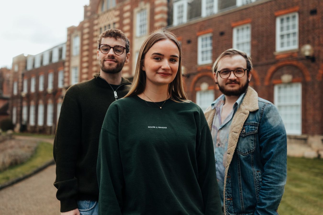 Three of Hull’s students stand confidently together in front of the business schools' beautiful listed buildings