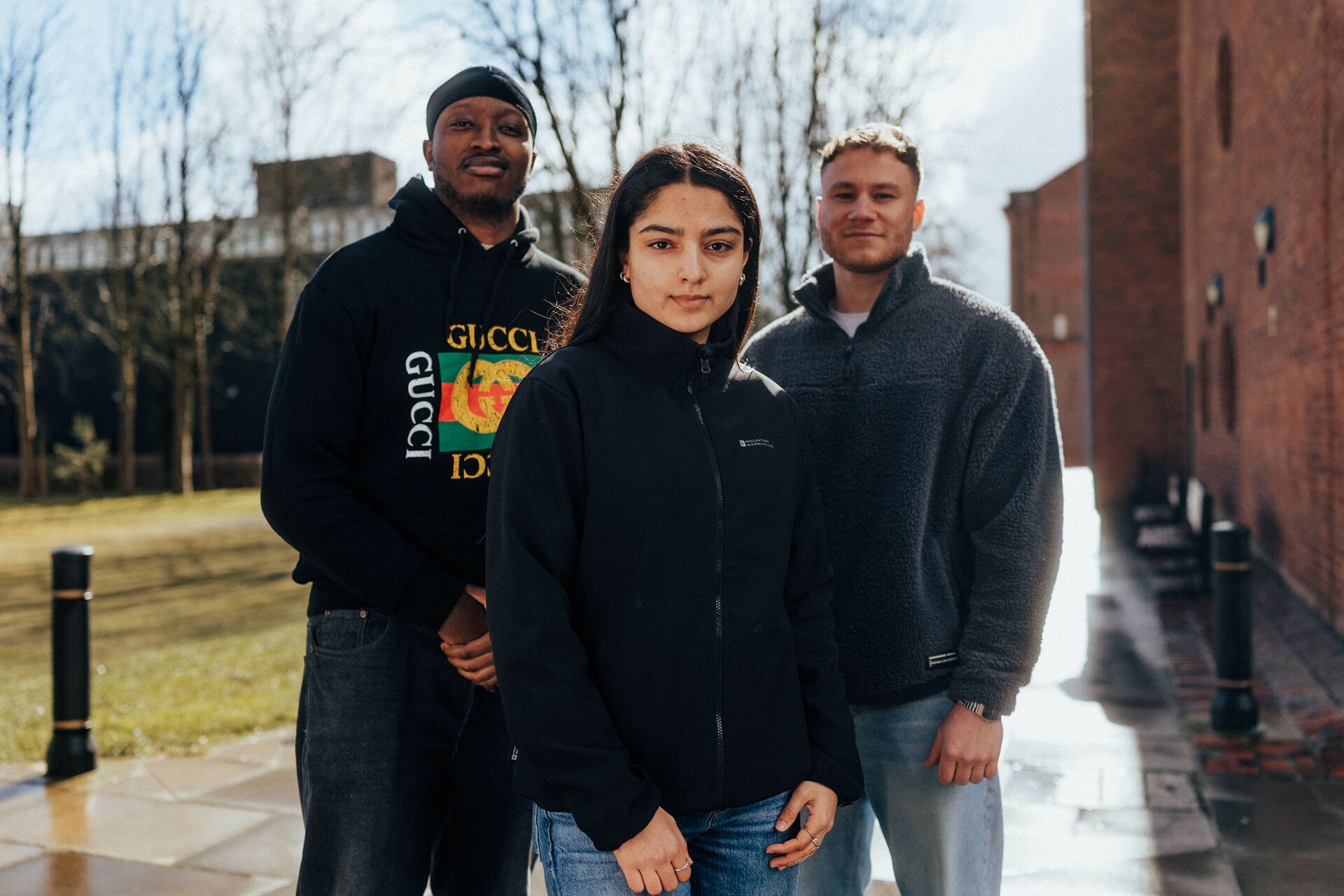 Three of Hull’s students stand confidently together on one of the campus' main walkways