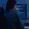 A student looking at a computer full of data