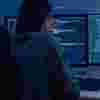 A student looking at a computer full of data