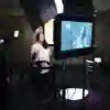 A student being filmed in a dark room