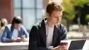 A student on a laptop on a picnic table