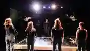 four students stood on stage