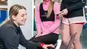 A group of students gathered around a laptop