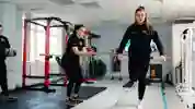 Two students in a rehab suite, one balanced on one leg