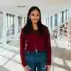 Student posing on balcony in business building