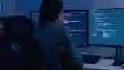 A student looking at a computer full of data
