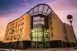 Exterior of the Allam Medical Building at dusk