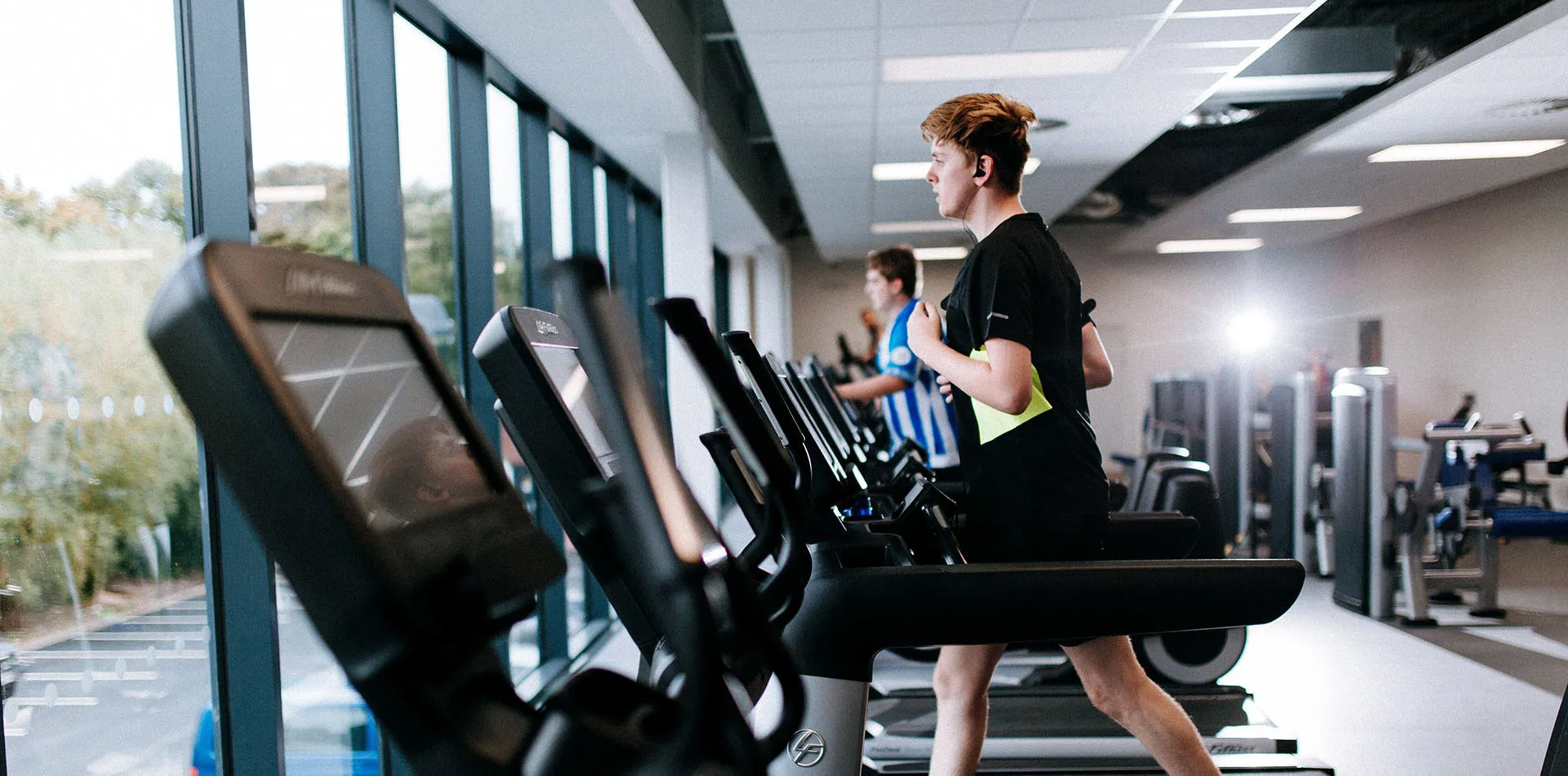 Student on treadmill looking out the window at Allam Sport Centre