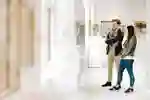 Students walking around the library art gallery