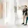 Students walking around the library art gallery