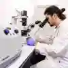 University of Hull Biomedical Sciences student in a lab with microscope