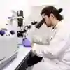 University of Hull Biomedical Sciences student in a lab with microscope