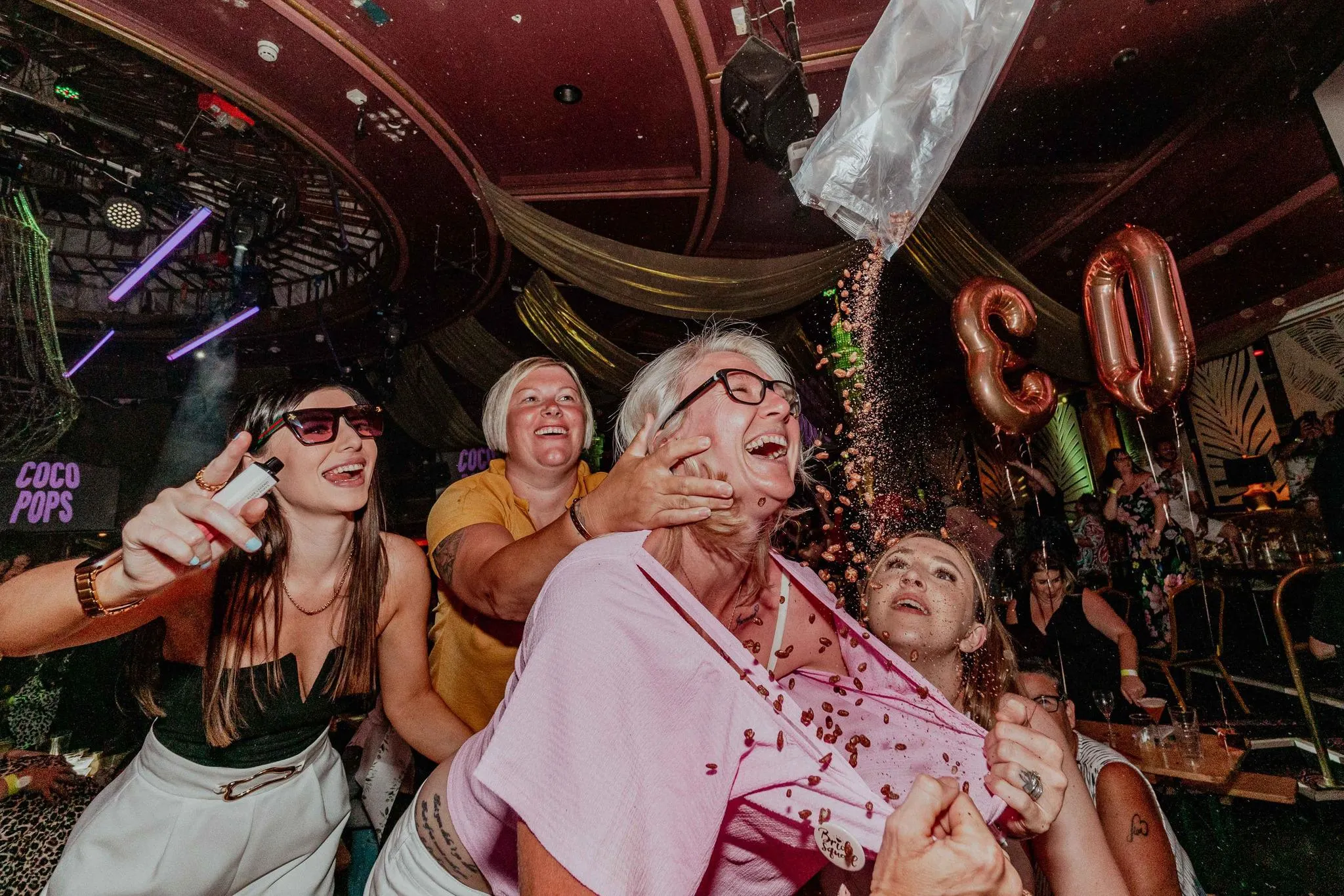 Bongo's Bingo image of people enjoying themselves tipping confetti down tops