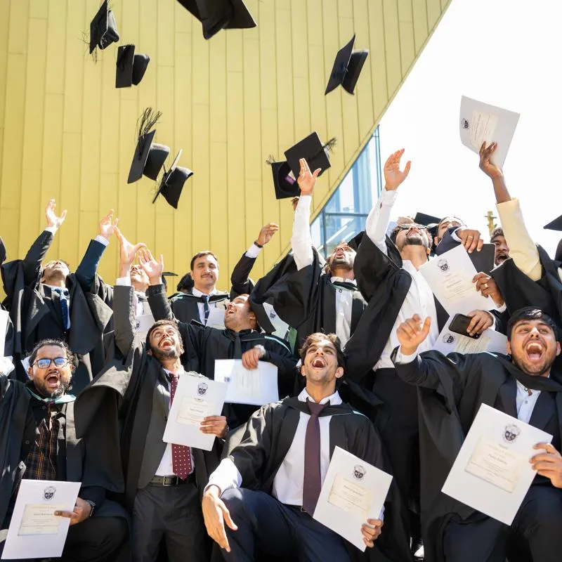 Graduates celebrating their degrees.