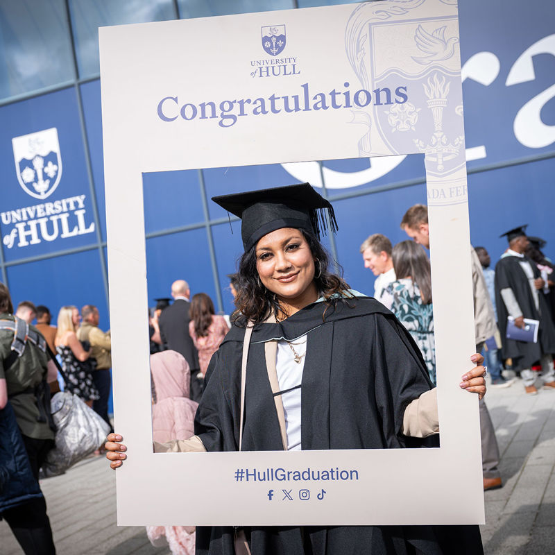 Graduand holding social media picture frame