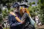 Graduand and reletive posing for ceremony