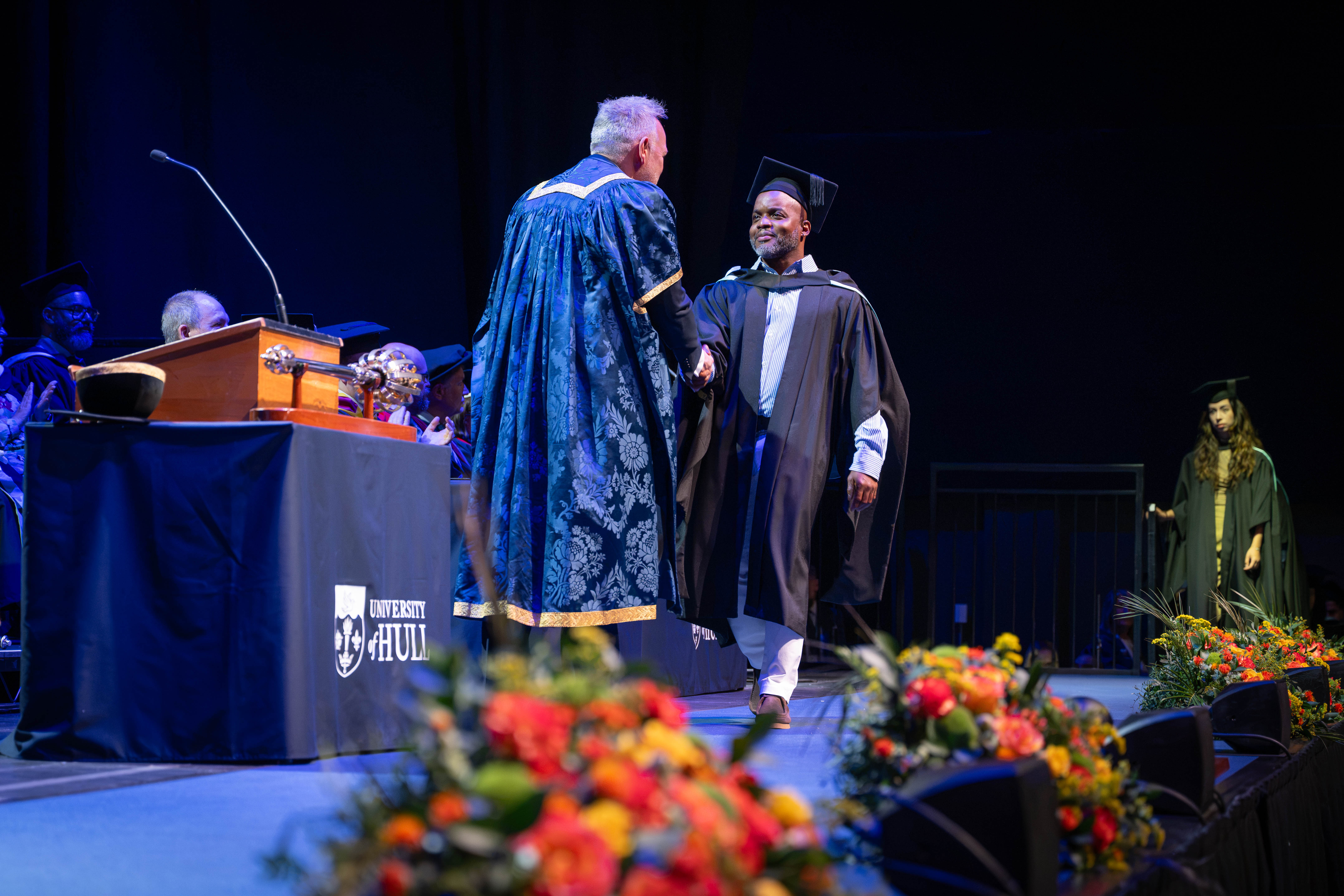 Graduate on stage with the Vice Chancellor. 