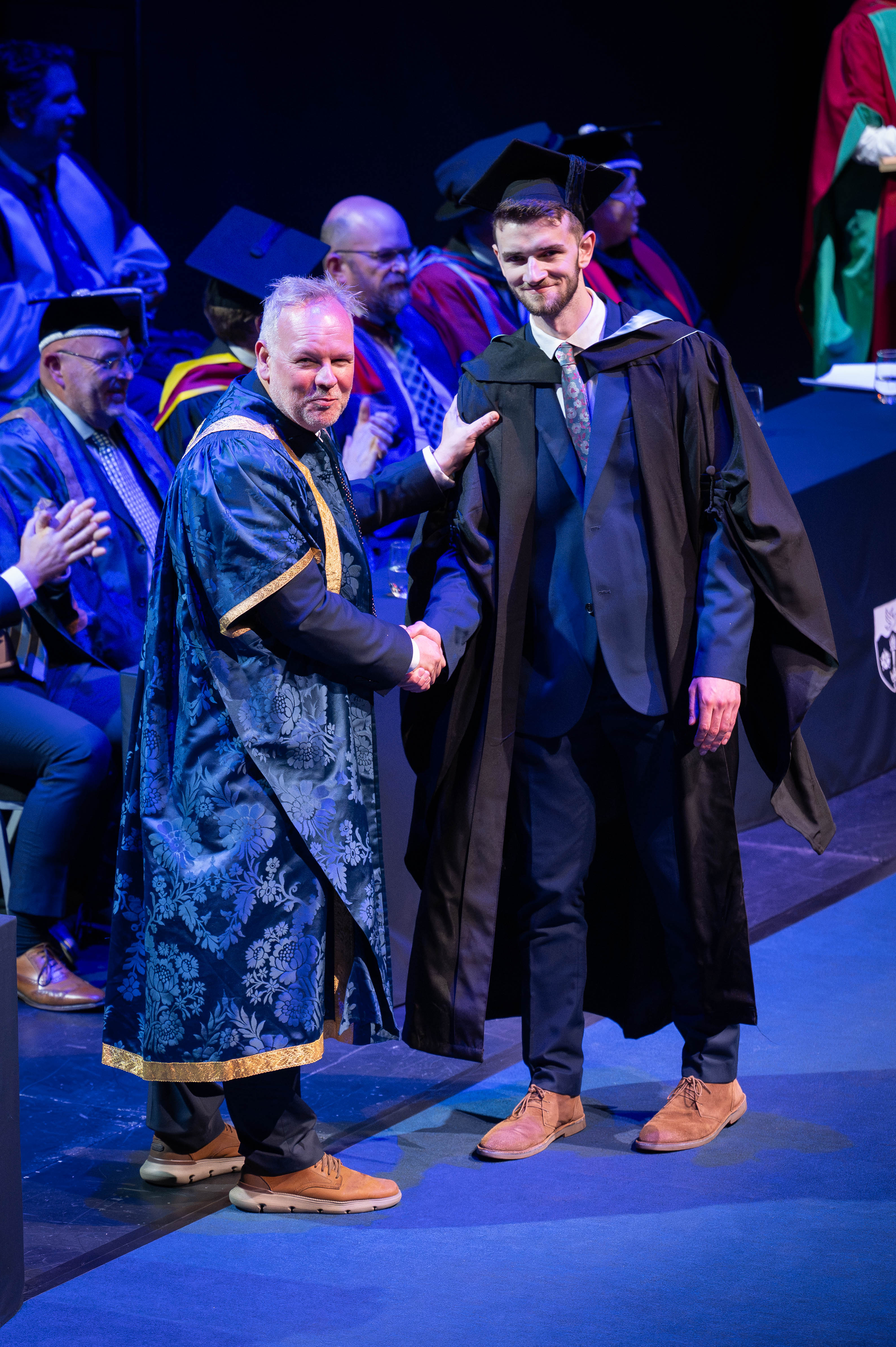 Graduate shaking the Vice Chancellors hand. 