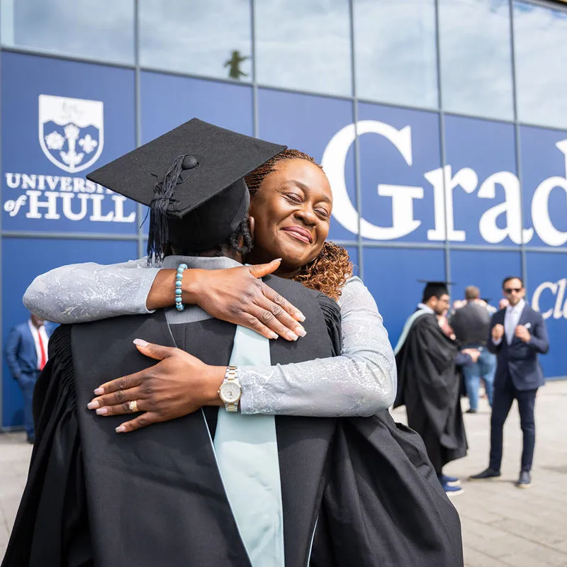 Graduating student in an embrace with her mum outside Connexin Live