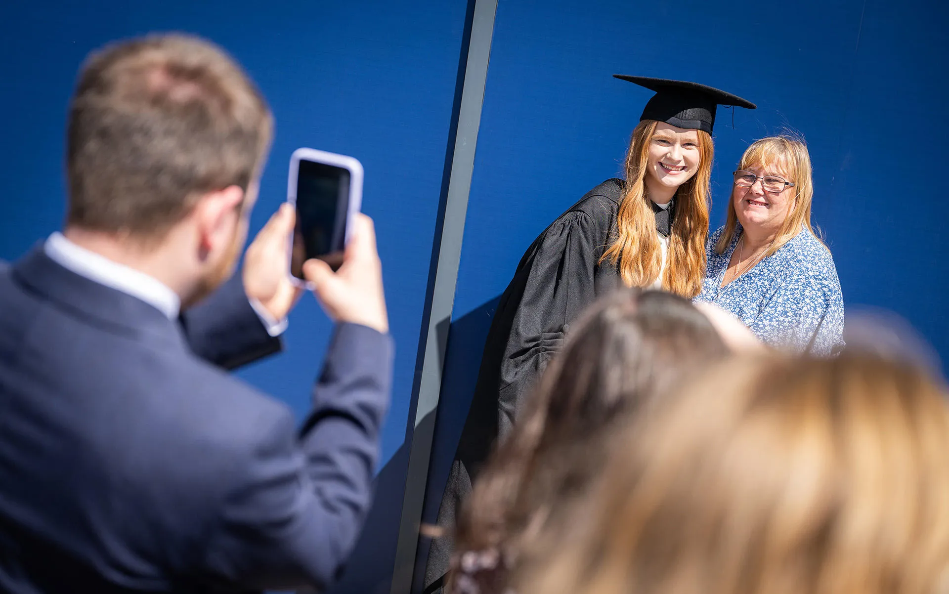 student and mum posing for a family graduation photo