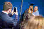 student and mum posing for a family graduation photo
