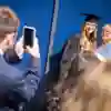 student and mum posing for a family graduation photo