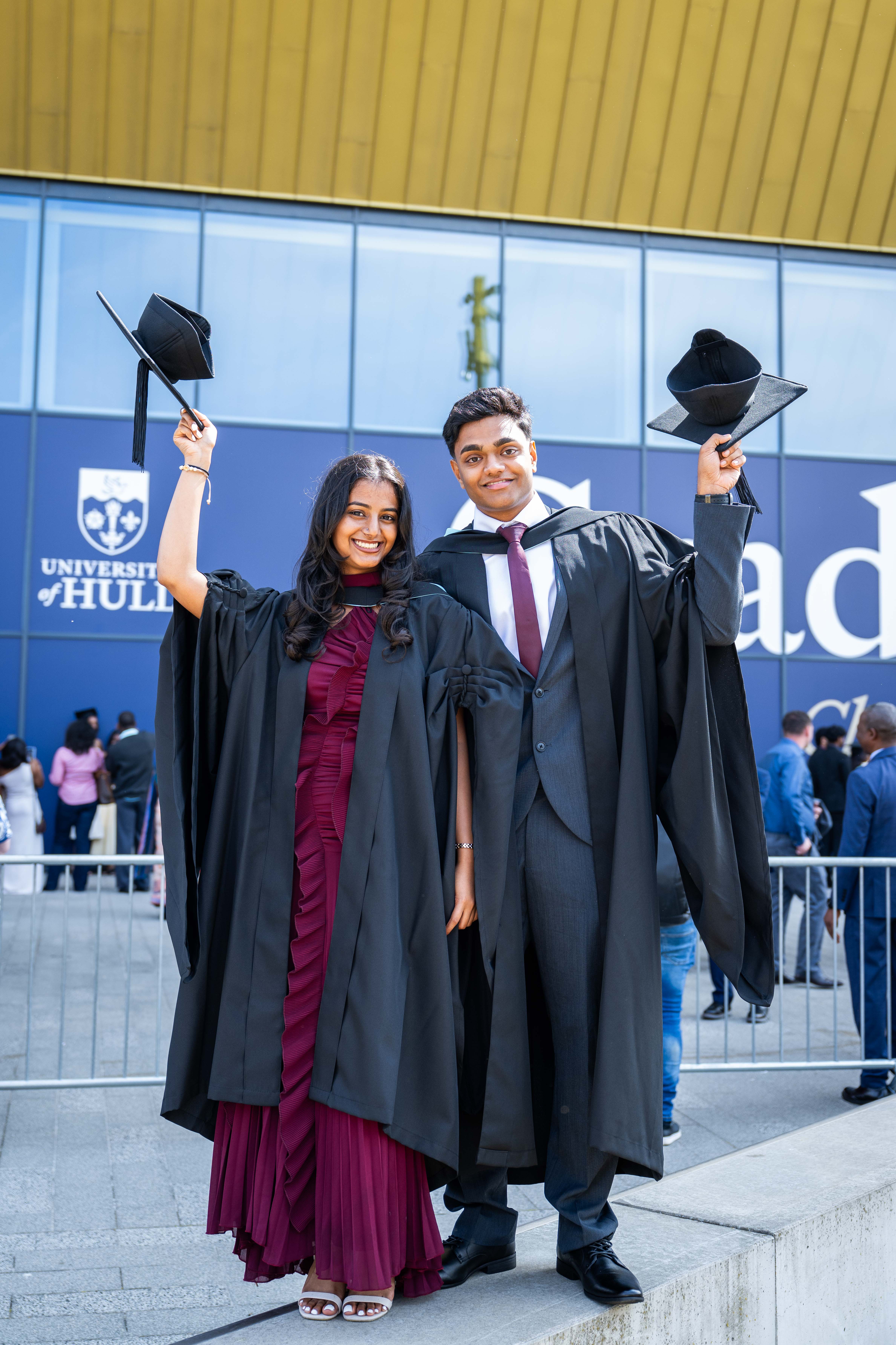 Two graduates celebrating their graduation. 